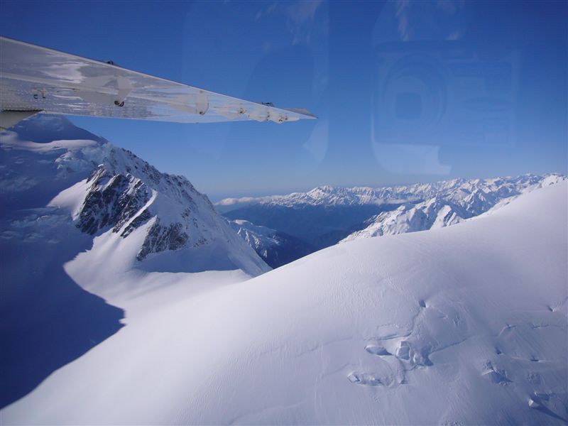 An aerial view of the glaciers, snow capped mountains and gorgeous glacial lakes.